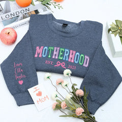 Motherhood Sweatshirt or Hoodie with Coquette Bow and Kids Names on Sleeve, Custom Embroidered Gift for Mother's Day