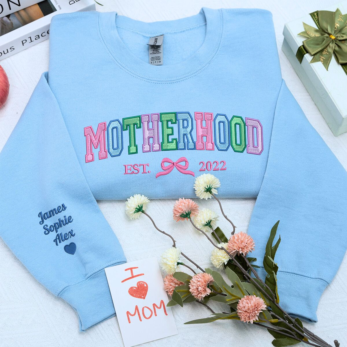 Motherhood Sweatshirt or Hoodie with Coquette Bow and Kids Names on Sleeve, Custom Embroidered Gift for Mother's Day